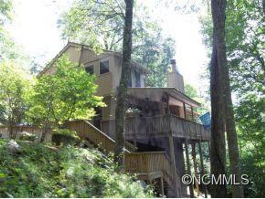 Immacualte maintained golf course chalet with great year round access. Cul-de-sac privacy warm and charming home. Cath. ceilings and stone fplcs in great room, bedroom and bath on main level , updated kitchen with tiled countertops.gas heat, central A/C, wrap around covered deck, detached garage. MANY EXTRAS, MUST SEE TO APPRECIATE!! Private community water system.