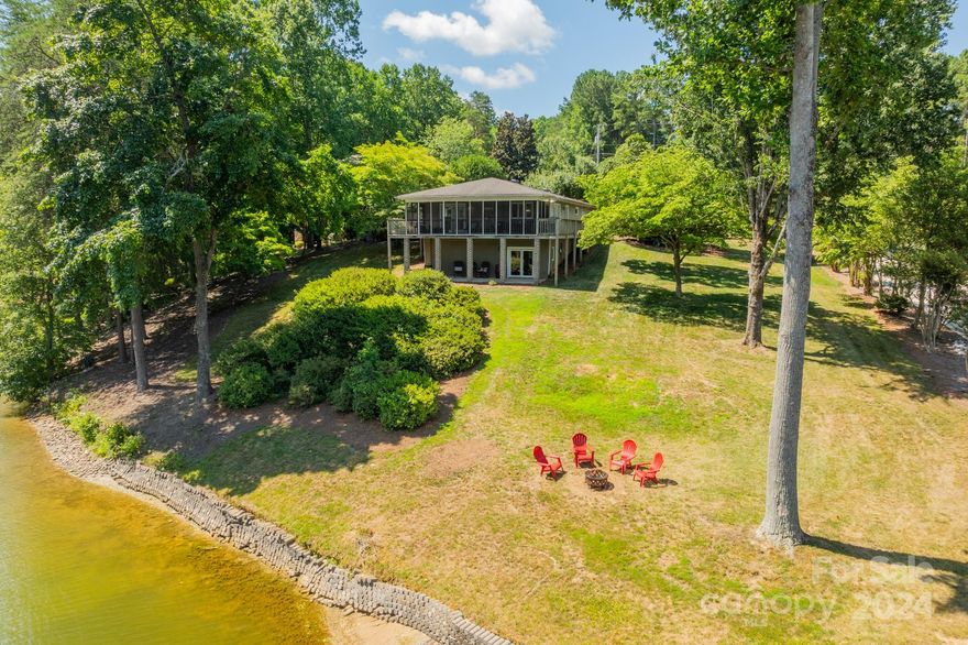 This waterfront cottage on Lake Norman offers an idyllic escape with over 200 feet of shoreline. The gently sloping lot provides deep water access, a private dock, and a covered boat slip, making it a haven for lake enthusiasts. Whether you're looking to build your dream home, use it as a short-term rental, or enjoy it as a personal lake retreat, this property offers flexibility with no HOA restrictions. Conveniently located near grocery stores and shopping, it combines the tranquility and beauty of lakefront living with modern conveniences. Enjoy stunning views and direct access to the water, making every day a perfect day for lake life fun!