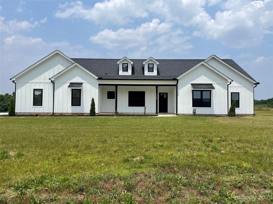 Take in the wide-open country views from the front porch of this new construction modern farmhouse ranch! On the outside, white hardboard siding and crisp black windows create a classic look. Inside a large open floorplan lends itself to entertaining family and friends. The modern kitchen with a large island opens up to a huge family room space with a vaulted ceiling and fireplace. The gracious living spaces extend out back to the vaulted covered patio area perfect for grilling and hanging out under the large fan. On the left side of the house is the primary suite with a luxurious bath. On the right side are two other bedrooms with two more full baths PLUS a dedicated private office. Plenty of in-kitchen dining space between the open breakfast area and island to compliment a large formal dining room and custom butler's pantry. A truly exceptional home in the heart of Union County's beautiful rolling fields. Gas logs installed. Buyer to establish and hook-up propane service.