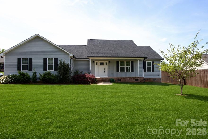 Welcome to this charming ranch home, situated in a rural setting, just minutes away from Hickory and downtown Lincolnton, with convenient access to Highway 321. This home features an open floor plan that seamlessly connects the living, dining, and kitchen areas, making it ideal for both relaxation and entertaining. The kitchen boasts modern grey cabinets, offeringa functional island for meal preparation. Retreat to the spacious primary suite, featuring a large walk-in closet and a luxurious primary shower and soaker tub. Designed for functionality, the home features a split bedroom plan, ensuring privacy for family members and guests alike. The detached garage offers ample space for a workshop, welding, or mechanics work, making it perfect for the hobbyist. Additionally, there is room for  RV parking to accommodate your outdoor adventures. This property presents a unique opportunity to enjoy country living while being close to urban amenities.
