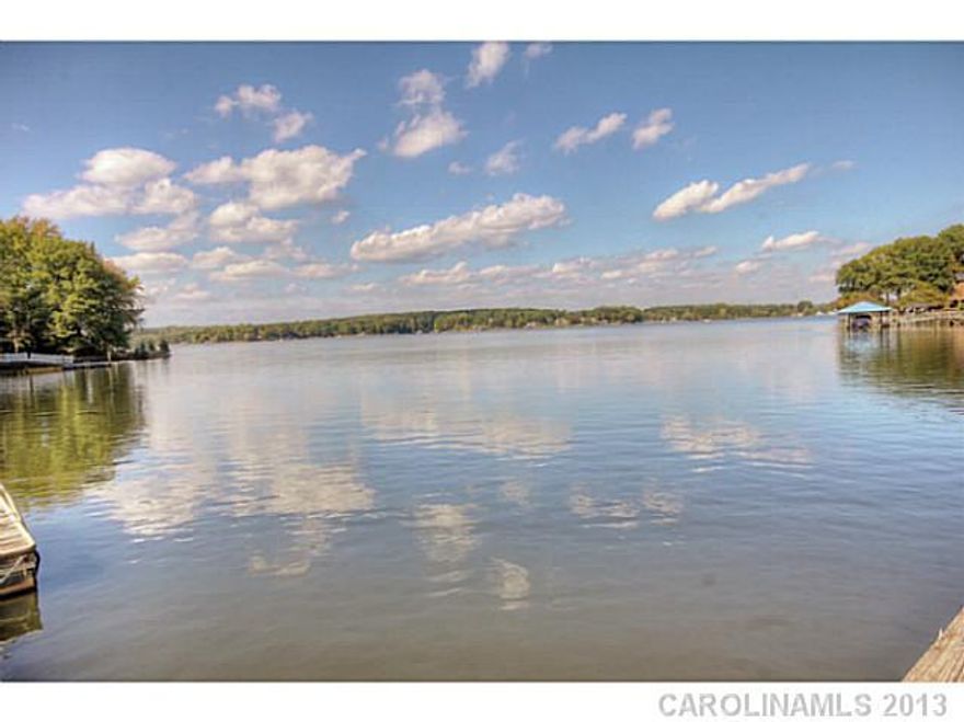 This cottage captures the charm and ambiance of a true lake lover's imagination. First time on the market, this home captures a simpler time. Situated on .93 aces this rustic waterfront home features 4 bedrooms, all with private baths, a private pier and a grandfathered boathouse. Enjoy relaxing times on the screened porch overlooking the lake or from the large living area beneath beamed ceilings.