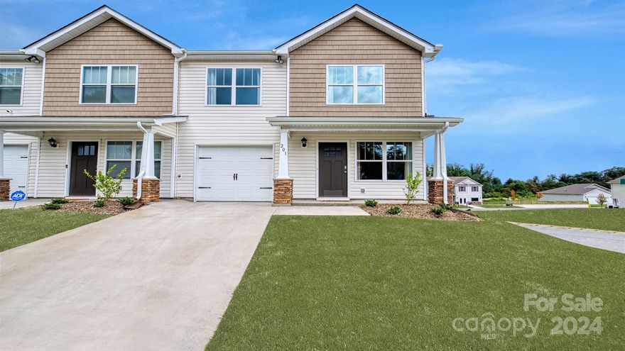 Wildbrook Village, a new community nestled just beyond the borders of Maggie Valley. Minutes from downtown Waynesville with a lively Main Street that has many local restaurants to choose from and charming stores for shopping. This 3 bedroom, 2.5 bath townhome offers a seamless blend of style and functionality. The kitchen has beautiful countertops, tile backsplash, shaker cabinets and stainless-steel appliances. Revwood flooring throughout the main level adds elegance and warmth to the home. *Home features are subject to change without notice. Internet service not included. Sq footages are approximate*
