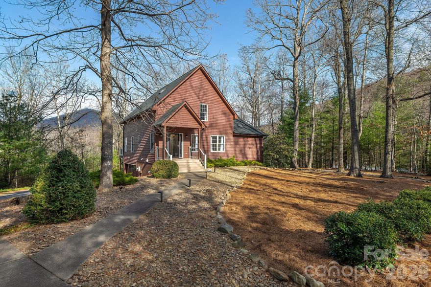 Beautifully appointed home in desirable Buffalo Mountain in scenic Riceville Valley, just 15 minutes from downtown Asheville. This thoughtfully designed residence offers an inviting floor plan, beginning with a welcoming living room that flows into a light-filled great room featuring walls of windows that showcase the surrounding natural setting. The main level includes a primary bedroom with an en-suite bath featuring a walk-in shower, walk-in tub and a spacious walk-in closet. The well-appointed kitchen offers an island and ample cabinetry, while the bright dining room with cozy gas stove, surrounded by windows, provides access to the rear deck, ideal for enjoying peaceful surroundings and scenic views. A laundry room and a convenient half bath complete the main level. Upstairs, the spacious second bedroom is within the loft area and features vaulted ceilings, a walk-in closet, an en-suite full bath and additional attic storage. The partially finished walkout basement includes a third bedroom with its own entrance and half bath, direct access to the garage, and a large unfinished area suitable for storage or workshop. On a beautifully landscaped lot, this home offers privacy and a strong connection to nature while remaining close to Asheville’s renowned dining, arts and cultural attractions, Blue Ridge Parkway, VA Medical Center and nearby Warren Wilson College. The listing agent can provide details about improvements. Whether seeking a full-time residence or a mountain retreat, this property delivers comfort, space and natural beauty within a short drive of Asheville. The Buffalo Mountain community also offers a variety of social activities throughout the year for residents to enjoy. See agent remarks.