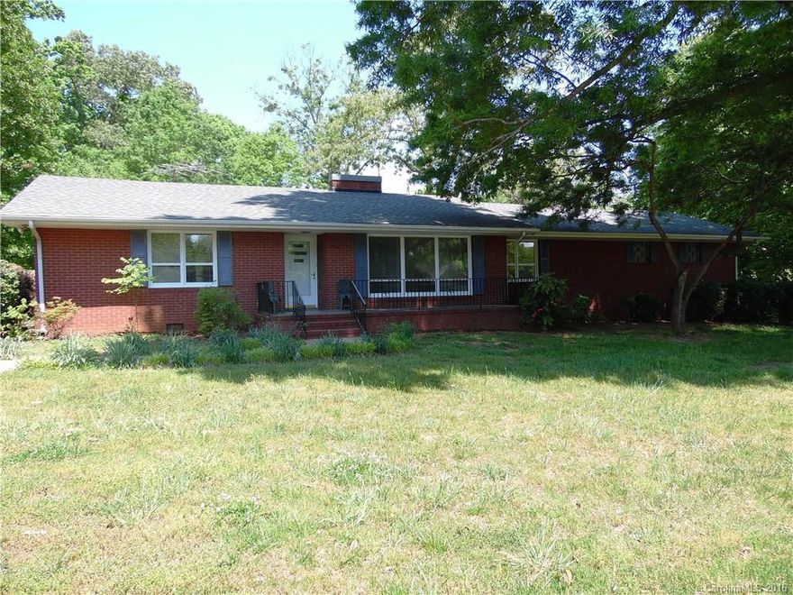 Brick ranch house & 4 acres along W Main Street in Albemarle - zoned RO. Entry features slate floors with slate fireplace in iving room, 2 bedrooms, 2 baths, den with fireplace and large sunroom. Rear entry garage with asphalt driveway.