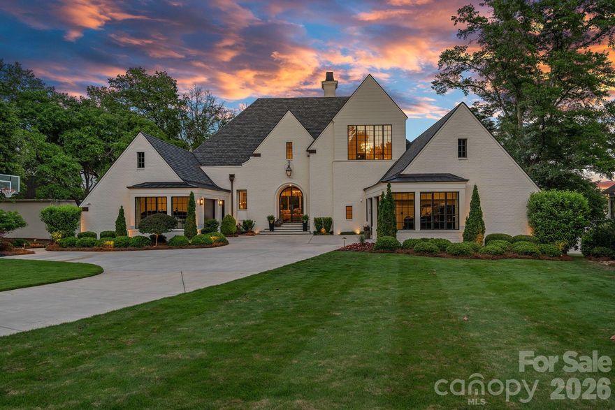 Experience luxury in this Modern English Tudor estate, nestled in the exclusive gated Live Oaks community on Lake Norman. One of just 11 homes, the neighborhood offers Southern charm with a canopy of imported live oaks, a koi pond with waterfalls, a sports court, and community docks. Designed by renowned architect Jim Phelps, this home blends timeless craftsmanship with modern elegance. A grand 10' staircase welcomes you, complemented by 5” white oak floors, rich wood paneling, custom ceilings, and designer lighting. The chef’s kitchen boasts custom cabinetry, marble countertops, and a 48” Thermador range, while a fully equipped scullery ensures effortless entertaining. The lower level features a full bar with a custom chandelier, bourbon display, wine room, gym, guest suite, and steam shower with aromatherapy. With over 120 feet of shoreline and a deeded dock, this home offers a serene lakefront retreat in one of Lake Norman’s most coveted communities.