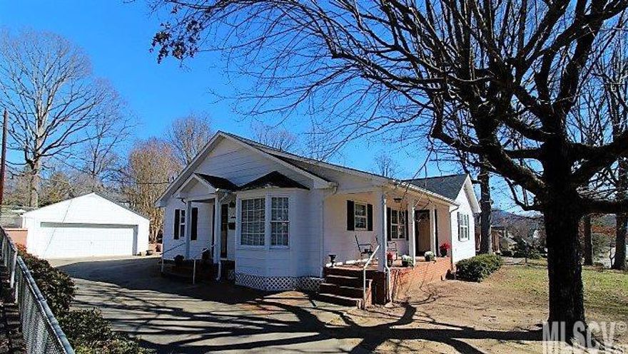THIS CUTE COTTAGE COMES WITH A LARGE FENCED LOT & LOADS OF OPTIONS! When entering from the covered rocking chair front porch, you'll be greeted by wood flooring & a bright, open feeling that continues throughout this cozy charmer. The LR opens into ample dining space, while the kitchen also boasts the perfect place for a breakfast nook; and, you'll enjoy using the 2016 stainless steel appliances there! A roomy MABR offers his/hers walk-in closets w/wood shelving, and a Lg BA w/dbl sinks. All of your storage needs are covered by a full basement, as well as the huge walk-up attic; so you can use that double garage for vehicles! Out back you'll find a nice patio spot for grilling & tons of parking for your friends! With a greenhouse waiting to be revitalized, a yard offering great gardening &/or play potential, a new inner fenced section for the pets; plus, The Walking Park & Downtown Lenoir just around the corner from this sweet n'borhood... WHAT ARE YOU WAITING FOR?