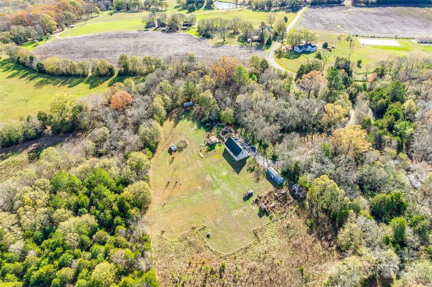 You do not want to miss this private retreat on over 6 acres! As you turn in you will drive down a private curved driveway leading up to the beautiful views of this property. Huge garden with a outdoor shower and chicken coop along with a covered patio and many perennials. Large open space and a fenced pasture. Inside you will find a large living room, open kitchen with a gas stove and a large laundry room. Two bedrooms, including the primary are located downstairs. Upstairs you will find two additional bedrooms and a full bathroom.