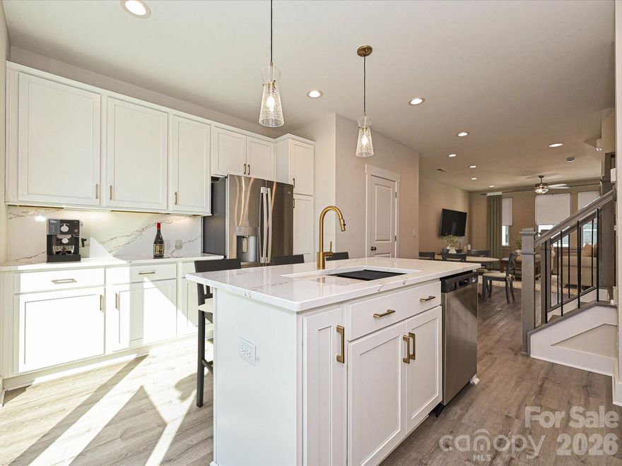 Enjoy a smart use of space in this new 4-story NoDa townhome, including 9' ceilings, 2-car tandem garage, & top floor Rec room with powder room & rooftop terrace. This space easily doubles as a guest bedroom! All kitchen and laundry appliances are included, w/ quartz counters & tiled floors in all full baths. Open layout on 2nd floor makes gatherings a breeze. Sliding doors off the kitchen lead to a small balcony, great for an urban herb garden or entertaining. Kitchen includes an island, 42" cabinets w/ trash pullout, quartz counters, tile backsplash, LED under-cabinet lights, pantry, large stainless steel undermount sink, & GE stainless steel appliances w/ gas range & French door fridge. 3rd floor laundry w/ GE stacked washer/dryer included. Premier Bath has a raised height-vanity w/ quartz counters & light grey painted cabs, tile floor, & large tiled shower w/ shampoo niche & semi-frameless glass. Low-maintenance LVP flooring at the garage entry, throughout the 2nd floor, & 3rd floor hall & laundry. Stairs have oak treads & straight black wrought iron balusters. Nook by the second floor stairs can host a desk for a home office area. 3 miles from Uptown Charlotte, close to N. Davidson St. and Plaza Midwood, plus walkable to restaurants. Quick ride-share to Optimist Hall and the LYNX light rail.