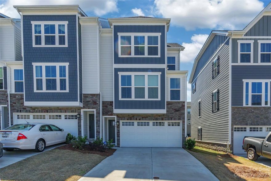 Luxury end unit townhome shows like a model! Open floor plan, bright and fresh. Over $50k in upgrades. You will want to start every morning on the extended covered back patio w/stonewall gas fireplace. Gourmet kitchen w/quartz countertops, SS appliances, double ovens and gas stove & pantry. Primary bedroom has trey ceilings and primary bathroom is upgraded to roman tile shower.  All bathrooms upgraded to tile. Main level bedroom suite & bath ideal for overnight guest stays. Drop your coat at the arrival zone by garage entrance. Fenced in backyard. Easy access to shopping, dining, and I77. Award winning Fort Mill Schools! Tega Cay amenities available including swim club or golf country club (additional fee) or the two lake front parks.