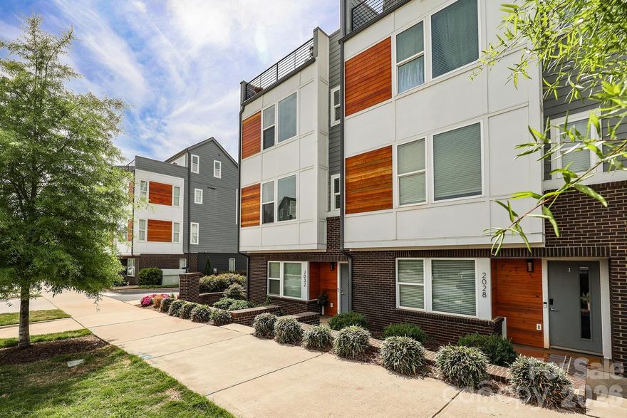 AMAZING UPTOWN VIEWS from your rooftop balcony! This is a former builder's Model Home with all the upgrades that come with it. Featuring upscale finishes such as 7-inch plank hardwood floors throughout, dark gray upgraded cabinets, quartz countertops, stainless steel appliances, distinctive lighting & more! Live in the heart of Charlotte’s dynamic FreeMoreWest neighborhood adjacent to the Legion Brewery, within walking distance of dozens of restaurants and shops along West Morehead and just 1 mile from Uptown C, close to greenways and parks, dog park in the community.