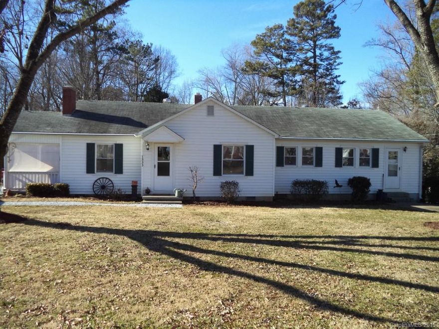 Charming home has many updates. large 1.2 acre lot and a huge 30x40 building/garage has 200 amp service. Beautiful hardwood flooring in all rooms except tile in the kitchen, baths and laundry. New heat pump, water heater and well in 2012. Insulated replacement windows. And you can have chickens-the coop is already there! Building is 2 story and could be used for storage or finish for a man cave.  Many possibilities! Fresh gravel in the driveway.