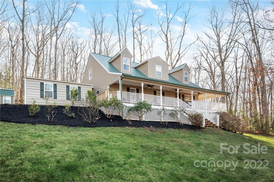 This charming farmhouse is located only minutes away from Biltmore Park, and less than 20 minutes from both Hendersonville and Asheville. You will be greeted immediately by the wraparound rocking-chair front porch, with beautiful winter mountain views. The main level features a large open kitchen/dining/living room, complete with original hardwood flooring and complemented by light-filled high ceilings. From the oversized primary bedroom on the main floor to the additional bedrooms and flex space loft upstairs, there is plenty of room for the whole family to enjoy. Situated on one acre, there is ample room to plant and play in the yard. The covered carport and storage shed are great additions, providing extra storage. Don’t miss seeing this lovely private home!