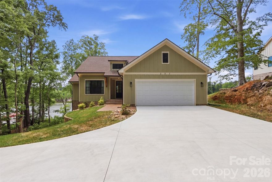 Stunning new waterfront home on High Rock Lake offering 2.17 acres of privacy and breathtaking lake living!
Arrive via a beautiful, tree-lined drive that opens to this nearly new home perched on 2.17 acres with views of High Rock Lake. Enjoy the ultimate waterfront lifestyle — relax on the expansive new 976 sq ft deck spanning the entire back of the home while watching stunning sunsets over the water, and access the lake anytime from your brand-new dock which includes a floating boat dock.
The spacious main level features an open living area perfect for family and friends, along with 3 bedrooms. The fully finished lower level offers even more flexibility with a large family room, kitchenette with dining area, 4 additional flex rooms (currently used as bedrooms and a gym), plus a generous storage room. The home is fully furnished and move-in ready.
This rare combination of new construction, generous acreage, and direct High Rock Lake access provides privacy, recreation, and relaxation all in one package. Whether you love boating, fishing, or simply unwinding with lake views, this is truly a special waterfront retreat. Property includes two tax parcels sold together. Buyer to verify all lakefront permits, shoreline regulations, and dock compliance with the lake authority.