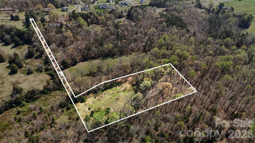 Rare opportunity to secure 5 acres in a growing pocket of Mooresville with approximately 1,000 feet of Driveway frontage (per survey). Located off Teeter Road and surrounded by mature trees, this property offers privacy, usable acreage, and flexibility for a variety of future plans.
Ideal for a custom home estate, modern farmhouse concept, or private homestead. The generous road frontage allows for an impressive private driveway entrance while maintaining separation from neighboring properties. There is ample space for a detached garage, workshop, pool, garden area, or recreational use — all within a peaceful setting. For builders and investors, this parcel presents strong potential in an area experiencing continued growth and demand. Convenient access to Downtown Mooresville, shopping, medical facilities, Lake Norman, and I-77 enhances long-term desirability and resale appeal.
Enjoy the quiet of country living while remaining just minutes from everyday conveniences. Opportunities combining acreage, road frontage, and location are becoming increasingly limited in Mooresville.
Bring your vision and your builder.