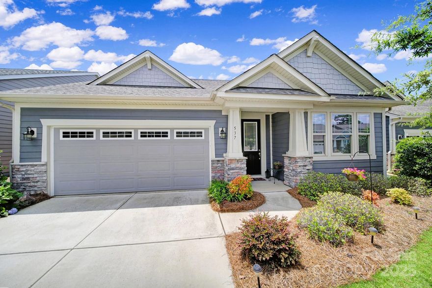 Welcome to easy, elevated living in Tega Cay! This immaculate home offers style, space & low-maintenance comfort, all nestled in a vibrant community w/ lawn care included. The heart of the home is a designer kitchen that impresses w/ granite countertops, gas cooktop, upgraded white cabinetry, a spacious island, wall ovens & custom vent hood. Enjoy seamless flow through the open-concept main level, where natural light pours in & highlights the spacious living & dining areas. Primary suite boasts incredible walk-in doorless shower & dual sinks. Step into the new 3-season room, perfect for relaxing year-round w/ peaceful views of the expansive green space just beyond the backyard. No rear neighbors, just open serenity. Upstairs, guests will love their private retreat complete w/ a large bedroom, full bath & a versatile loft/bonus room. Situated in one of Tega Cay’s most desirable communities including a neighborhood pool & park near Lake Wylie with the ease of a lock-and-leave lifestyle.