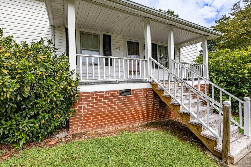 This bungalow is nestled on large lot in city.  It fronts Depot, but drive entrance is off Troy Alexander Dr .Previously Franklin St. When you turn on Troy Alexander Dr. off Depot St, you will see paved drive to right pass 1st house.  It is at the end of the drive   The home has 2 bedrooms  living rm, dining rm, kitchen, covered back porch.  Washer/dryer hookup in  kitchen closet & also detached garage Seller uses Garage washer/dryer hookup.  1 bedroom & bath have concrete floors under flooring.  Seller says Heat Pump was installed end of 2022,  hot water heater approx 6 years old, house roof approx 2010.   Seller built new building 1998.  It is plumbed for a bath, but not installed.  Gas Heater in Double detached garage does not work AC works.  Drain in floor of garage.  Living room has scuttle in closet to attic.  Dbl detached garage has pull downstairs.  little white dog's name is Stella. 
One bedroom does not have closet.