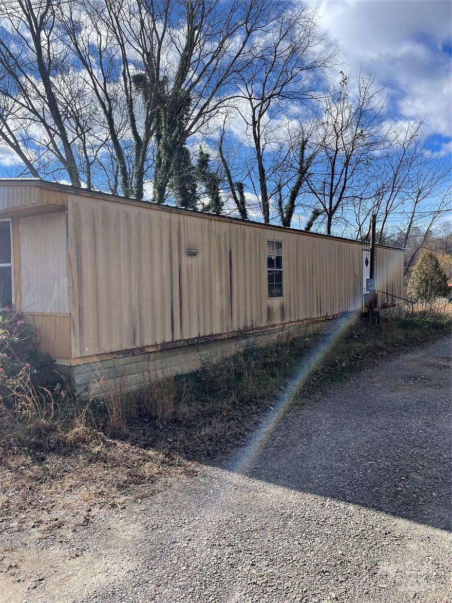Stripped down 1982 Singlewide 2 bed 1 bath. 840 sf. No appliances, soft floors  Mobile Given no value.  Property being sold for the land which is a .69 acre lot.