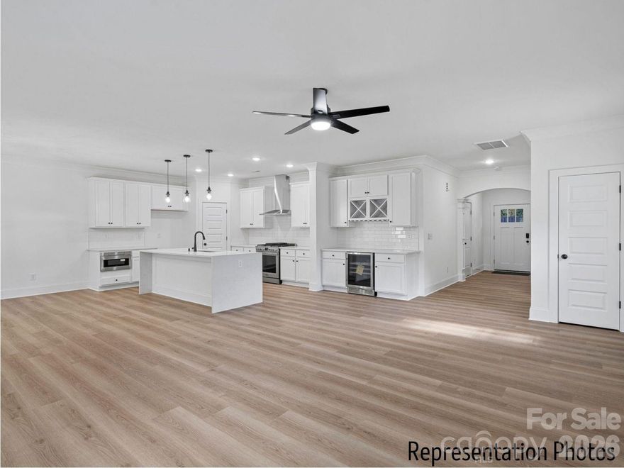 In the heart of the highly desirable Cotswold area of Charlotte with desired schools.  This beautifully appointed duet-style home offers the space and feels like a single-family residence without the single-family price tag and with NO HOA dues. Thoughtfully crafted by SouthCraft by EMPIRE HOMES, every detail reflects intentional design and elevated finishes that make everyday living feel refined.Step inside to discover a bright, open floor plan designed for both functionality and luxury. The kitchen serves as the heart of the home, seamlessly overlooking the dining and living areas, making it ideal for gathering and entertaining. A stunning waterfall Carrara quartz island anchors the space, complemented by 42” cabinetry with soft-close drawers, wide plank flooring, a gas range, microwave drawer, designer hood, and dishwasher. A custom wood-shelved corner pantry. An extended beverage bar add thoughtful convenience, perfect for hosting, setting up a coffee station, or grabbing a quick energy/hydration drink on your way out the door.Nine-foot ceilings on both floors create an airy, expansive feel, while high-end molding adds architectural depth and sophistication throughout. Just off the dining area, an extended sunroom fills the home with natural light and opens to a spacious deck complete with a gas stub line so you’ll never worry about running out of propane before guests arrive.Upstairs, all bedrooms are generously sized and thoughtfully positioned for privacy. The primary suite feels like a true retreat, featuring a custom wood-shelved closet system designed for both beauty and organization.   A tankless water heater ensures you’ll never run out of hot water, enhancing comfort and efficiency. Architectural shingles and Low-E windows further elevate the home’s quality and energy efficiency.Outside, the backyard offers endless potential. Whether you envision a custom entertaining patio, a future pool, lush landscaping, or a private outdoor sanctuary, the deep, level yard provides the perfect canvas.This is more than a home, it’s an opportunity to enjoy luxury finishes, modern functionality, and exceptional value in one of Charlotte’s most sought-after neighborhoods.