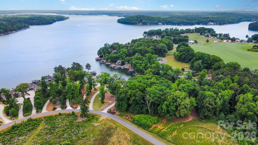 Beautiful waterfront lot on lake Tillery in gated community. The +/- 1.14 acre lot is situated in a small cove that opens to the main channel. This lot is located in an area that allows a boathouse, however, buyers should verify with Duke Energy about the lease and size of the boathouse permitted.