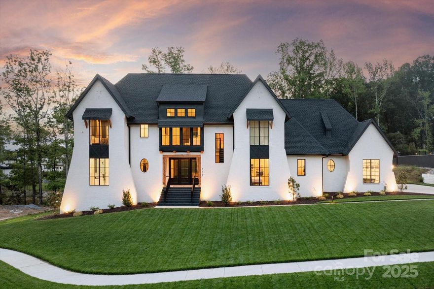 Gorgeous custom home located on premium lot with water view. This home includes an open floor plan with wide plank white oak hardwood floors, scullery kitchen, designer lighting and a contemporary linear gas fireplace with custom ceiling height tile surround. The kitchen features a 10 foot quartz island with waterfall edge, custom cabinetry with under cabinet floor lighting, 2 dishwashers, built in fridge and freezer, gas cooktop with commercial hood, double ovens + an oversized galley sink. Floor plan features a primary on main w/ luxury bath + an additional guest room with full bath on the main floor + a dedicated office w/ custom built in cabinetry. Upstairs, there are 3 generously sized secondary rooms, each with an ensuite full bath, plus a bonus room. Home also features a 2900sf unfinished basement and large secondary patio. Outside, enjoy the resort backyard featuring a beautiful salt water pool, upper level screened porch with gas fireplace and outdoor kitchen + putting green.