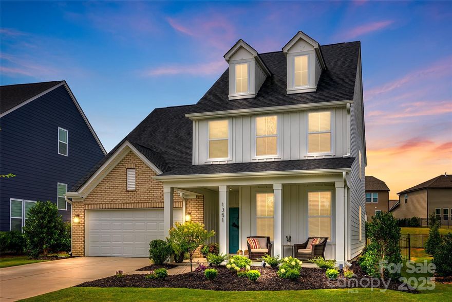 Beautiful home in vibrant Paddlers Cove in Clover! Cozy rocking chair front porch. Enter the home and you are greeted w/ gorgeous panel molding in the foyer. Bedroom on main provides flexibility for guests/or home office. Formal dining room w/ tray ceiling. Gourmet kitchen is a chef's dream w/ ample cabinets, farmhouse sink, quartz countertops, large kitchen island,  buffet/coffee bar and large panty. Great room features a cozy gas fireplace & large picture window overlooking the backyard. Lovely wood staircase leads upstairs to the loft w/ endless possibilities. Spacious primary bedroom w/ tray ceiling, bath w/ an oversized roman  shower with neutral tile, dual vanities and spacious walk in closet. Two secondary bedrooms, both feature beautiful custom molding and walk in closets. Backyard oasis with covered patio and fenced backyard. Wonderful amenities - sidewalks, outdoor pool, playground & Field Day park. Great location -convenient to schools, shopping & beautiful Lake Wylie!