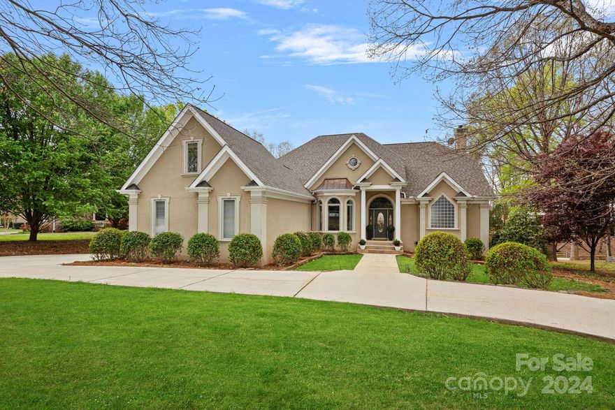 If the perfect waterfront location is what you desire, this is it! Located just outside The Point in a private cove, this home is an entertainers dream with so many possibilities. The very desirable floorplan boasts an oversized gourmet kitchen with tons of storage, a breakfast room with floor to ceiling bay windows overlooking the lake. The kitchen adjoins a two story great room with water views, and a statement fireplace. The main level primary suite is equipped with a large walk in closet and access to the deck. All bedrooms are ensuite with large walk in closets and water views. Upstairs, a large bonus room could be a great flex space. In the basement, a room currently used as a bedroom overlooks the lake and back patio. A full bath, media room and home office could easily be converted into private living space with it's own entrance and garage. For car and water enthusiasts there are TWO garages along with extensive storage space. Gorgeous mature landscaping front and back.