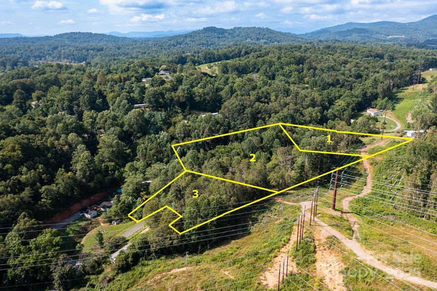Opportunity awaits in North Asheville with this recently subdivided tract on Flynn Branch. Three separate, unrestricted lots are available—each listed at $125,000, or purchase all three for $375,000. Build one home or create your own private compound in the mountains. Each lot includes land on both sides of the quiet road, preserving privacy and granting access to an adjoining stream. Bring the builder of your choice, or consult with our recommended local builder. A rare chance to enjoy a serene, wooded setting just a short drive to town.