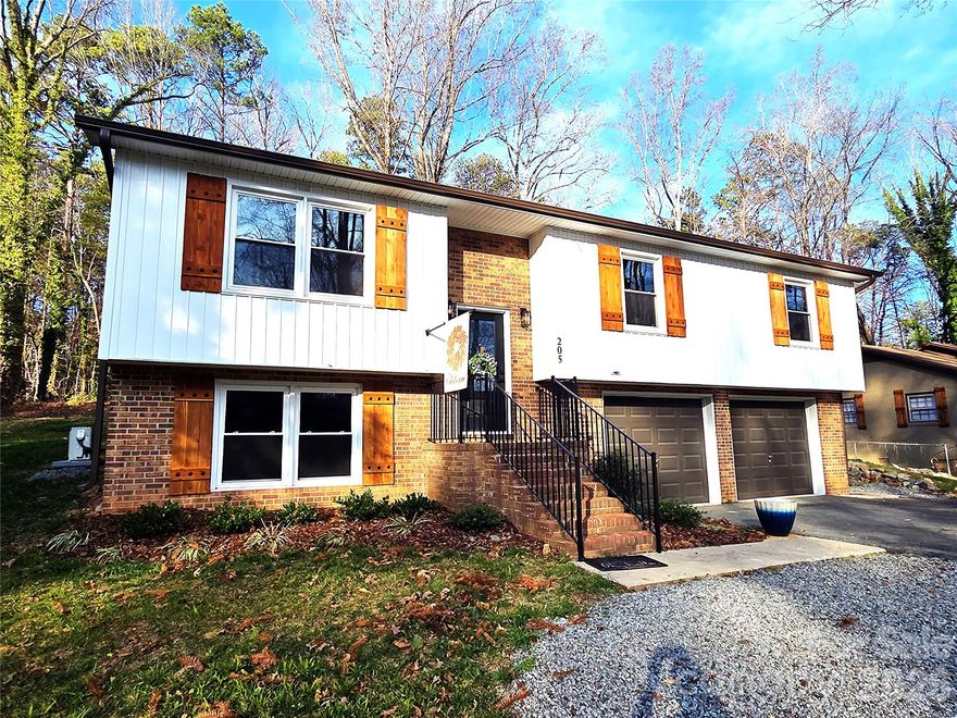 Stunning total remodel from foundation to roof! This nearly 1,900 sq ft home offers 3 bedrooms and 3 full baths, plus a fully finished lower-level second living quarters with private access. Every major system is brand new, including plumbing, electrical, 30-year roof, HVAC, and water heater—providing true peace of mind.

The interior features a complete custom upfit with new walls, paint, doors, Low-E windows, and lifetime 28 mil LVP flooring throughout. Designer details shine with matte black fixtures and lighting, custom stair railings, and distinctive river-run matte black interior doors.

**Two brand-new kitchens—one on each level—**both showcasing sleek European cabinetry, quartz countertops, soft-close doors and drawers, and custom tile backsplashes. Bathrooms are equally impressive with unique lighting packages and elegant marble tub and shower surrounds.

The lower-level suite offers approximately 500 sq ft of flexible living space with a full bath, full kitchen, and a high-quality mini-split heating and cooling system—ideal for multi-generational living, guests, or rental potential. Additional highlights include a custom 12x16 deck, private access to the lower level and garage, a 2-car garage, and dedicated workshop space.

A truly one-of-a-kind property combining luxury finishes, flexibility, and modern efficiency.