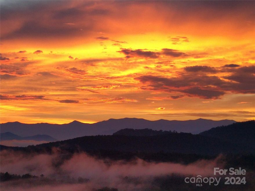 A million-dollar view for nearly half the price! This private 14 acre retreat on a sleepy cul-de-sac in gated Grandview Peaks development has it all! A warm & cozy log home w/ 3-bay garage includes oversize space for all your toys.  Perched atop a hill, this home's 220-degree vista spans six ridges across the Blue Ridge Mountains, viewed from porches on all 3 levels. Offered partially furnished. 1,500-watt off-grid solar array with battery backup – providing uninterrupted emergency power day or night & reducing overall power consumption year-round.  Stunning sunsets, a private community lake, walking trails & security gate – this property offers safety, security & privacy in a perfectly-sized mountain hideaway. Among the largest lots in Grandview Peaks, the "buffer" surrounding this home, like the view, is permanent.  2 spacious BRs, a relaxing loft & lower level ideal for play & projects with a walk-out and full bath. Hiking trail & stream on property. This homestead truly has it all!
