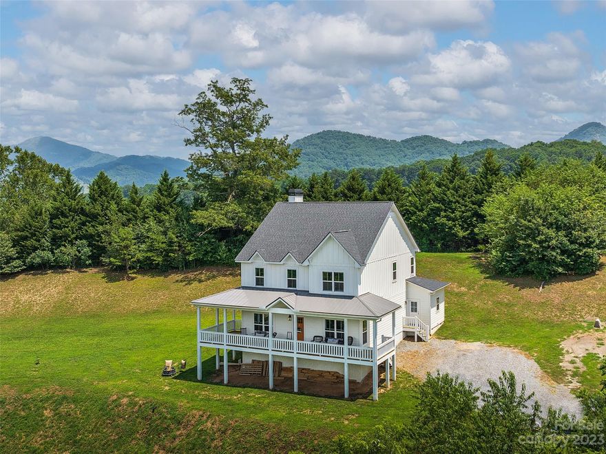 Modern farmhouse was custom built in 2022. Sited on 1.24 acres the home faces year round mountain views and seasonal river views. The open concept living is one of the highlights of this home, 10 foot main level ceiling height, 9 foot second floor ceiling height and lots of windows to bring in lots of light. Home offers a spacious greatroom with a large island, Quartz countertops, SS appliances with induction cooktop,and a pantry. Breakfast area off of kitchen, living area with wood burning fireplace, and beautiful exposed beams. 3-BR/2.5BA, large primary suite with clawfoot bathtub, ceramic tile shower, walk-in closet, laundry conveniently located to bedrooms with many more features.  Large covered front porch to enjoy the views, back deck and conveniently located to Waynesville and Asheville.