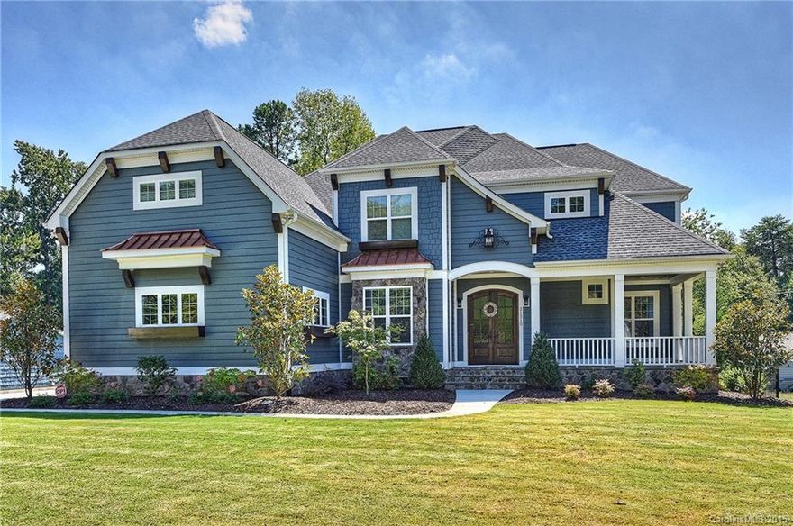 Meticulous custom builder's own home. Full wet bar with incredible sunset views. Large gourmet kitchen with 48" gas range, pot filler, exquisite granite, recycled glass backsplash, & copper farmhouse sink. Huge covered flagstone front & screened porches. Flagstone back porch with stone fireplace overlooking the large, heated custom pool & spa provide tons of outdoor space. Master bed down overlooks the pool and includes master bath with 4 jets/2 showerheads, frameless glass & limestone shower.