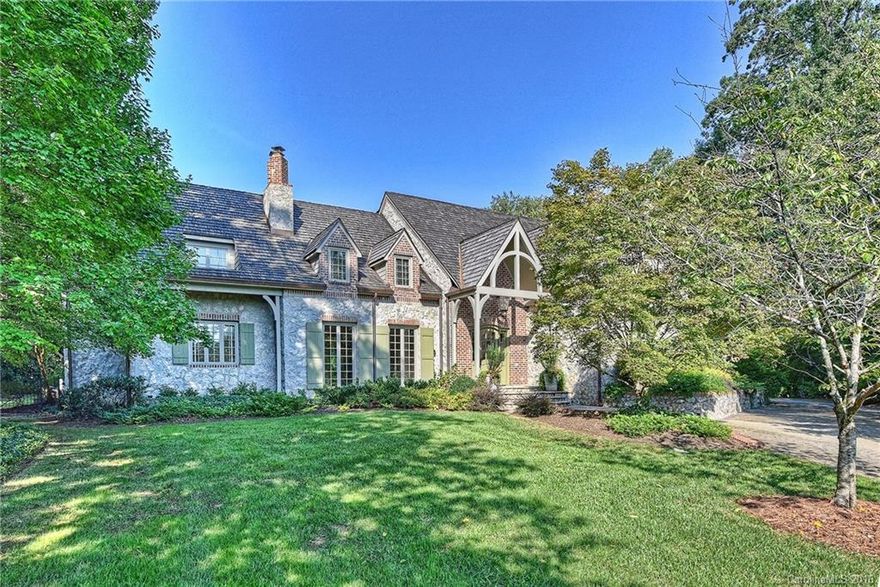 Gorgeous stone home in exclusive gated neighborhood just minutes from Uptown. Gourmet KT w/exposed beam & paneled ceiling features Chef's grade gas range, pot filler, warming drawer & island w/butcher's block top. Wet Bar w/oversized wine frig, sink & glass front cabinetry. DR w/vaulted ceiling & magnificent wooden beams. Great Room off KT w/exposed beam  ceiling, access to outdoor living space & stone fireplace. Step-down LR w/fireplace. MSTR on main, generous rec room on upper level w/cozy