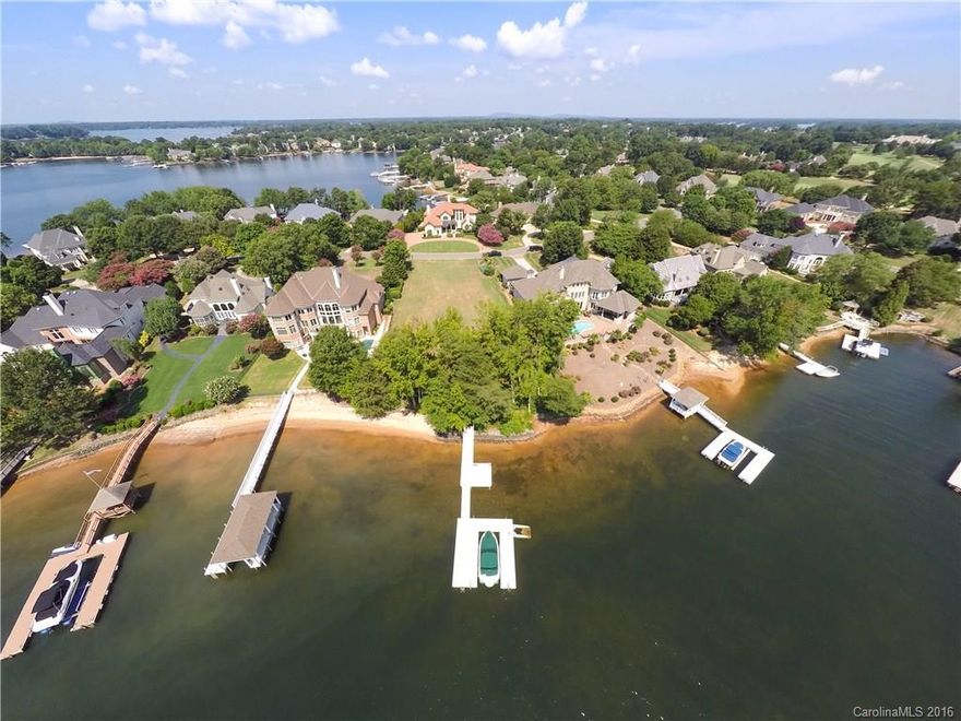 Hard to find prime waterfront building lot w 176 feet of shoreline in Lake Norman's Peninsula Country Club & Golf Course community. This gently rolling lot is ready to go with a Dock, Boat Lift, Sandy Beach & shoreline stabilization in place. Mainsail Pointe Dr. is a beautiful established street within walking distance to the Club. Make sure to view the drone video of this lot.
