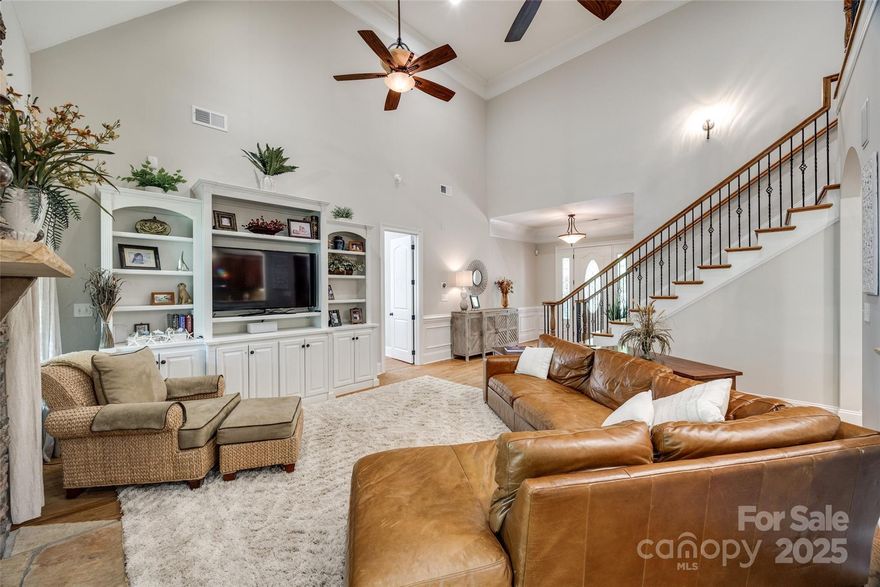 WELCOME HOME! Live the life you always wanted in this custom brick & stone, 4 bed/4 bath luxury home w/ seasonal water views & new luscious landscaping.  Inside, the custom built-ins, moulding & attention to detail are abundant. The 2-story great room features gas fp & open floor plan.  The gourmet kitchen is a chef's dream w/ lots of cabinets, granite countertops & s/s appliances. A dining area connects to a cozy keeping room boasting a built-in bar w/ bev fridge & floor to ceiling stone fp. Main level primary bedroom is a grand retreat w/ a multi-functional attached room w/ French doors leading to a covered porch. The updated bath features garden tub, dual vanities & 2 walk-in closets. Above the spacious 3-car garage is the ultimate bonus rm. Upstairs you will also find 2 bdrms w/ en-suite baths & a built-in computer niche. Unfinished walk-out bsmt is waiting for your finishing touches & is pre-plumbed for 2 baths.  New paint, carpet, 50 gal wtr htr, landscaping & ext. lighting.