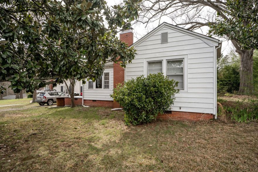 Hers is your chance to get a spacious home in an excellent location near downtown Concord, McGee park, and the greenway! This home is ready for the next owners with recently purchased Samsung refrigerator and washer and dryer along with new HVAC (2022) and hot water heater (2020). The home offers two bedrooms along with a third room that could be used as an office, rec room, den, or formal dining room along with a spacious living room w/ fireplace. The kitchen has an eat-in dining area as well as an attached laundry room with space to add shelving for pantry items. The corner lot boasts great yard space and a nice buffer between neighboring homes. The side porch is a great space to relax outside... it would be easy to screen in to have a nice screened porch area.