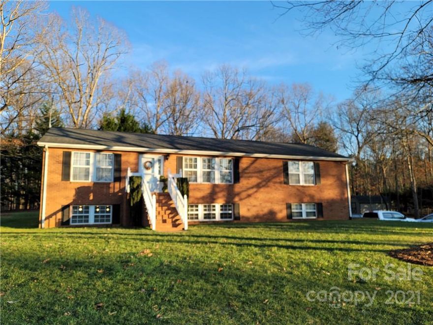 Private lot with tons of room in this 3BR/3BA ranch with full basement! Large living room and kitchen/dining area; walk-in closets in all 3 bedrooms; basement is heated/cooled and partially finished with large family room, full bath, office (could be used as a guest bedroom), and art studio/flex space. Double garage in basement with workshop area; large rear deck with wheelchair/handicap ramp; wheelchair accessible bathroom on main level with roll-in shower; recently updated kitchen; new furnace in 2021; outbuilding for storage or additional workshop area. Must See!