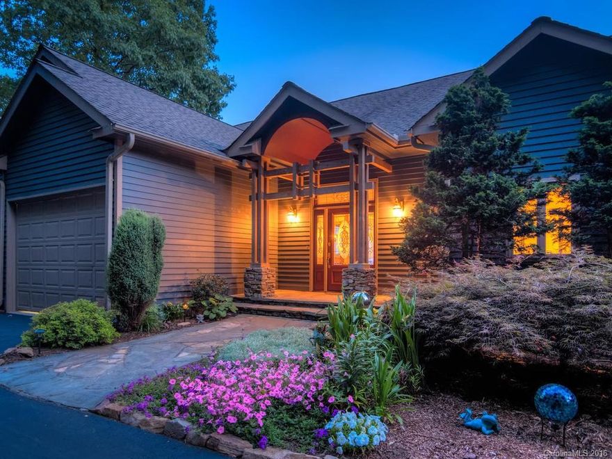 Contemporary Arts & Crafts with expansive, panoramic, long-range views from every room. Custom architecture, chef's kitchen, and outdoor spaces for entertaining and relaxing.  On over three private acres, this extraordinary home has an open and airy floor plan, exquisite living spaces inside and out, and lovely gardens featuring stacked stone walls and a serene waterfall.  Only ten minutes to Downtown Asheville and less than five minutes to the Blue Ridge Parkway. Perfection on Town Mountain.