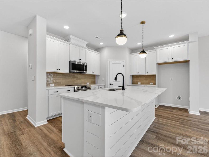 This stunning new townhome in Westview Towns is situated on a private wooded homesite, featuring tree-lined views that go on forever. With this new townhome in Waxhaw, NC, you can embrace a low-maintenance lifestyle close to the conveniences and charm of Downtown Waxhaw.Step inside and discover the large, elegant gourmet kitchen featuring luxurious quartz countertops, an oversized island plus extraordinary cabinet space, making the ideal space for creating both culinary delights and memories in this stunning heart of the home. Sophisticated touches throughout include a beautiful staircase featuring wooden treads, adding a touch of warmth and elegance. 
Oversized windows throughout the home bathe the space in natural light. Step outside and enjoy the privacy of your wooded backyard with nothing behind you but trees! Relax and unwind on the covered rear porch knowing the included lawn maintenance will free you up to spend your time on the things you love.