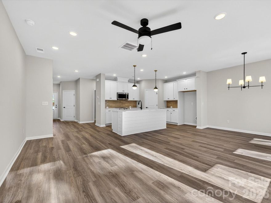 This stunning new townhome in Westview Towns is situated on a private wooded homesite, featuring tree-lined views that go on forever. With this new townhome in Waxhaw, NC, you can embrace a low-maintenance lifestyle close to the conveniences and charm of Downtown Waxhaw.Step inside and discover the large, elegant gourmet kitchen featuring luxurious quartz countertops, an oversized island plus extraordinary cabinet space, making the ideal space for creating both culinary delights and memories in this stunning heart of the home. Sophisticated touches throughout include a beautiful staircase featuring wooden treads, adding a touch of warmth and elegance. 
Oversized windows throughout the home bathe the space in natural light. Step outside and enjoy the privacy of your wooded backyard with nothing behind you but trees! Relax and unwind on the covered rear porch knowing the included lawn maintenance will free you up to spend your time on the things you love.