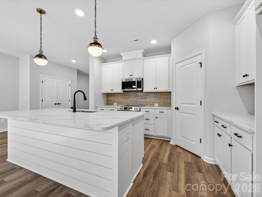 This stunning new townhome in Westview Towns is situated on a private wooded homesite, featuring tree-lined views that go on forever. With this new townhome in Waxhaw, NC, you can embrace a low-maintenance lifestyle close to the conveniences and charm of Downtown Waxhaw.Step inside and discover the large, elegant gourmet kitchen featuring luxurious quartz countertops, an oversized island plus extraordinary cabinet space, making the ideal space for creating both culinary delights and memories in this stunning heart of the home. Sophisticated touches throughout include a beautiful staircase featuring wooden treads, adding a touch of warmth and elegance. 
Oversized windows throughout the home bathe the space in natural light. Step outside and enjoy the privacy of your wooded backyard with nothing behind you but trees! Relax and unwind on the covered rear porch knowing the included lawn maintenance will free you up to spend your time on the things you love.