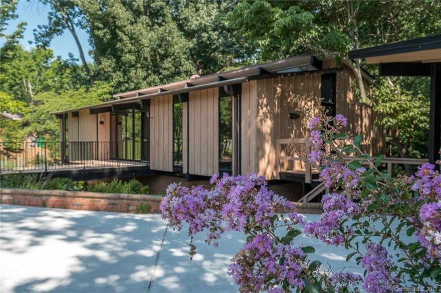 Rare & unique mid century modern home one of a kind custom built mid century modern, lovingly cared for and landscaped, this home has four bedrooms, 2 and a half bathrooms, living areas upstairs & down w/exceptional private wooded views.  Dual balconies run length of home, feels like you have mountain living in the heart of SouthPark.  The pictures tell the story!  Neutral paint and neutral carpet. 2 car carport -- home on culdesac.  Washer/gas dryer included.  Landscaping included in the rent.