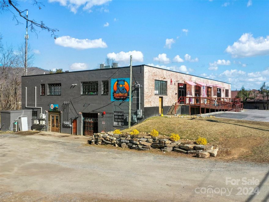This 19,700+ sq ft commercial space on approx 1.5 creekside acres is a fantastic opportunity, currently thriving as a highly successful restaurant/brewery, but is an ideal location for a variety of uses including an event venue, church, storage units, grocery store or even divided it could house multiple businesses and offices. 
Featuring a welcoming atmosphere with 300+ seating, a fantastic bar area, and all new/updated kitchen equipment. Additionally, enjoy amenities such as an arcade, axe throwing booth, cornhole court and virtual golf! 
Do not miss this highly flexible space with over 10,000 sq ft of basement space a blank canvas and with town approval for roof top bar and seating, the possibilities for future expansion or development are endless. 
With Western NC being a top destination for wedding venues this could be the perfect addition to the limited selection of event venues in the area and positioned to become an industry leader!  Nestled in the center of Waynesville, this property is 5 minutes from downtown historic Waynesville and the extensively renovated, Waynesville Inn Golf Resort&Spa, A Bobby Weed designed 18 hole championship course, part of the Tapestry Collection by Hilton. Located in an area known for pristine water and a destination for outdoor enthusiasts with 18 mountain peaks over 6000 feet! Cherokee/Harrah Casino, Cataloochee Ski Resort, the Blue Ridge Parkway, golfing, Mountain biking, hiking and world-class fly fishing are all nearby. Properties in area are rapidly being purchased and developed in this fast growing area of Haywood County.  Act now to secure this ideal property for your future plans! This is one of three locations currently for sale in Haywood County. The other two are 339 Park St., Canton, and 4352 Soco Rd. Maggie Valley