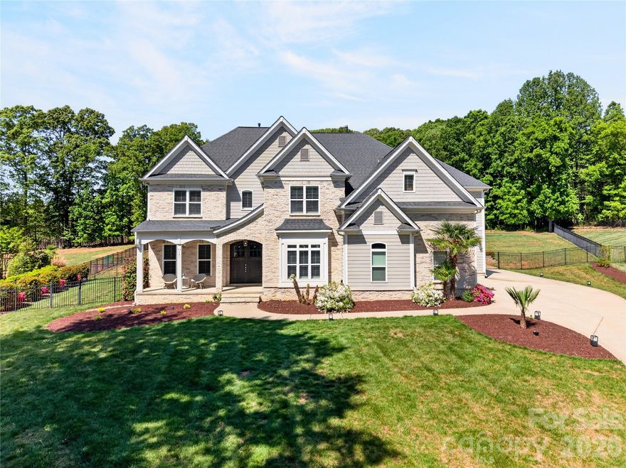 Behind the private gates of The Enclaves at Chesapeake Pointe, this exceptional estate redefines refined living with a seamless blend of sophistication, comfort, and resort-inspired design. Nestled on an expansive 1.80-acre homesite, the property offers a rare sense of privacy, enhanced by a fully fenced backyard sanctuary. Step outside to your own curated oasis—an extraordinary outdoor retreat designed for both relaxation and entertaining. The heated, resort-style pool features an elegant tanning ledge with bubblers, complemented by a separate in-ground spa, creating an ambiance reminiscent of a five-star getaway. Inside, every detail has been thoughtfully considered to elevate the living experience. The main level showcases a private executive office, ideal for working in style, along with a versatile fitness studio that can easily adapt to your lifestyle needs. The heart of the home is a luminous, chef-inspired kitchen adorned with pristine white cabinetry, designer countertops, and an expansive island with bar seating, in addition to a charming built-in dining nook, perfect for casual gatherings or morning coffee. Flowing effortlessly from the kitchen, the inviting keeping room features a striking stone fireplace flanked by custom built-ins, offering warmth and architectural elegance. The grand great room impresses with its scale and sweeping views of the outdoor retreat, creating an ideal setting for hosting guests in style. An expansive formal dining room that is currently reimagined as a sophisticated recreation lounge, offers endless possibilities, from an upscale entertaining space to a private retreat tailored to your passions. This remarkable residence is a masterclass in luxury living, where every space has been designed to inspire comfort, connection, and effortless elegance. Ascend to the upper level, where the private quarters continue the home’s theme of elevated luxury and thoughtful design. The primary suite is a true retreat, an expansive sanctuary designed for rest and indulgence: featuring dual walk-in closets, including an extraordinary, boutique-style dressing room the size of a bedroom, curated to showcase even the most discerning wardrobe. The secondary bedrooms are generously proportioned, offering both comfort and privacy. One suite enjoys its own private bath, while two additional bedrooms are connected by a beautifully appointed Jack-and-Jill bath, blending convenience with refined style. The third level unveils a versatile bonus suite complete with its own bathroom, an ideal space for a private guest retreat, media lounge, or elevated entertainment space. Even the everyday essentials are elevated here with the well-appointed laundry room that impresses with abundant cabinetry and expansive counter space, designed to make daily living as seamless as it is stylish. Completing the home is a spacious three-car garage, offering ample room for vehicles, storage, and recreational pursuits. And when it’s time to unwind, the covered rear porch provides a shaded escape that is perfect for enjoying tranquil evenings overlooking your private outdoor haven. This extraordinary residence offers a lifestyle of comfort, elegance, and distinction at every turn.