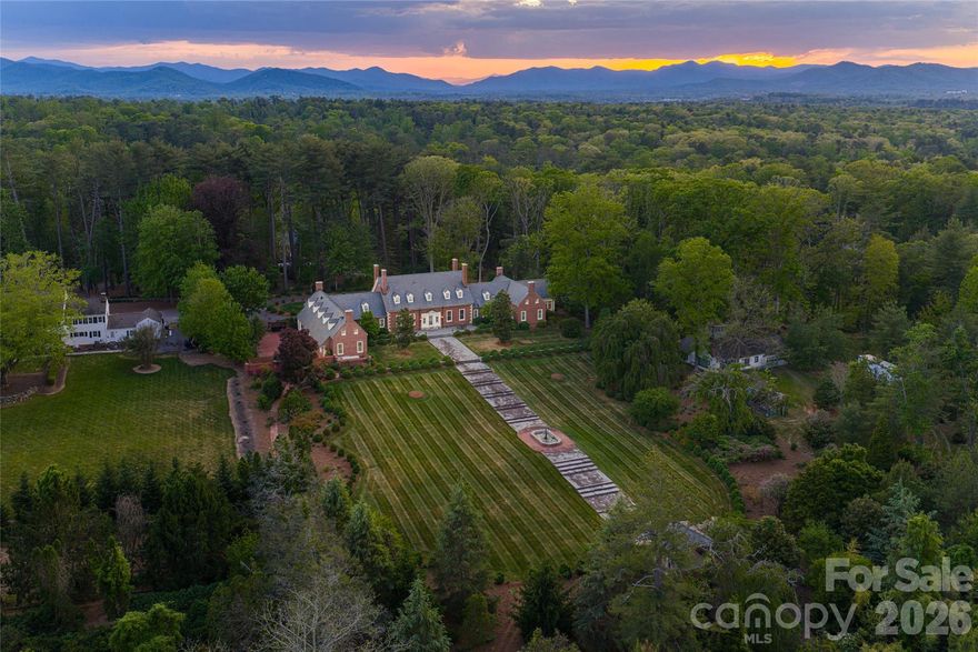 Atop one of the most distinguished ridge lines in Biltmore Forest, 324 Vanderbilt Road is a landmark estate of remarkable provenance, scale and architectural significance. Known as New Gunston Hall, the residence was completed in 1923 as one of the first homes ever built in Biltmore Forest and remains among the community’s iconic properties. Inspired by the historic Gunston Hall in Virginia and designed by renowned architect Waddy Butler Wood, the Colonial Revival estate is listed on the National Register of Historic Places and represents a level of craftsmanship and permanence rarely seen today. Behind its gated entrance, more than 11 acres unfold with a level of privacy, scale and presence rarely found so close to Biltmore Village and downtown Asheville, creating an extraordinary sense of arrival while remaining moments from the city’s premier dining, shopping and cultural amenities. Constructed with enduring materials including Flemish bond brickwork and slate roofing, the home spans approximately 8,688 square feet and balances historic grandeur with refined livability. Extensive renovations completed between 2013 and 2016 thoughtfully preserved the architectural integrity of the residence while incorporating modern systems, updated infrastructure and elevated finishes throughout. Rich millwork, elegant formal spaces, a distinguished library and meticulously restored details reflect the craftsmanship of another era, while the scale and flow of the home create an environment equally suited for intimate daily living and large-scale entertaining. The grounds are among the estate’s defining features. Rolling lawns, mature trees, formal gardens and exceptional privacy create the feeling of a private country estate tucked within one of the Southeast’s sought-after communities. Properties of this caliber and historical significance rarely become available, particularly within Biltmore Forest. New Gunston Hall is more than a home, it is a legacy estate with an irreplaceable place in Asheville’s architectural history.