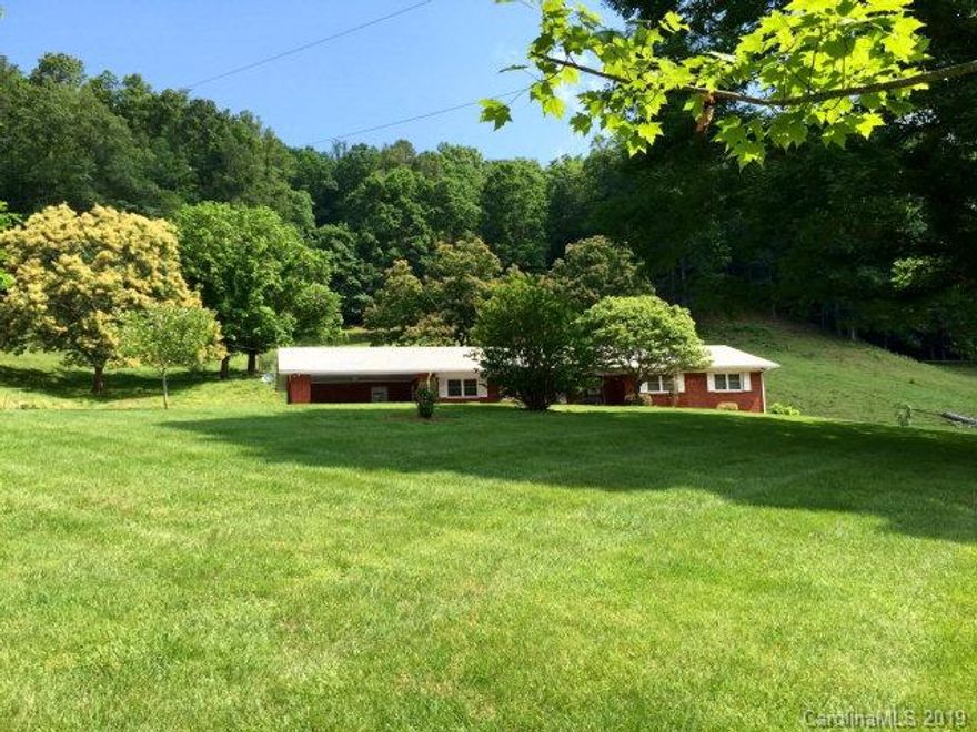 Once in lifetime offering. +/- 46 acres. Borders Pisgah National Forest to north, Catawba River head waters to south (state supported trout stream). 1 mile to Catawba River State Park. +/- 1900 sq. ft. brick rancher, 3 BR, 2 BA, full basement, new kitchen, 3 water sources (2-wells, 1-spring), move in ready. Multiple additional building sites on property with long range mountain views. Livestock barn, approx. 10 ac. of fenced pasture, 25 minutes to downtown Asheville. Property can be easily converted to support livestock, organic farming, orchard/vineyard, campground, and/or commercial/private development.