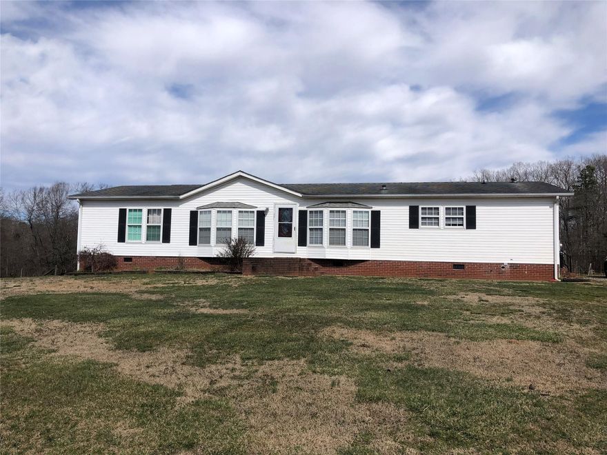 Welcome to this spacious 3 bedroom, 2.5 bath home on 4.72 acres. This open floor plan offers a large living room, dining room, and family room with fireplace, each with abundant natural light! Kitchen has great storage with lots of cabinets, a pantry, and mobile island. Mud/laundry area and 1/2 bath off kitchen. Generous primary bedroom with walk in closet. Primary bath with double vanity, garden tub, and separate shower. The 2 additional bedrooms  have walk in closets as well. Outside you'll find a wonderful rural retreat. Partially fenced for fun and adventure with gardening, a mini farm, or to simply enjoying country living, on this quiet street in beautiful Cleveland County. Don't miss the mature trees and the stream on the back of the property. Building to convey.