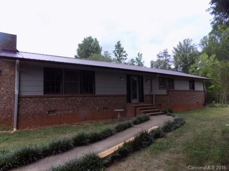 Brick ranch on over 5 acres has so much to offer. Home features large kitchen with plenty of cabinet & counter space, formal dining room, large living area & split BR plan. Several outbuildings provide ample storage space. Large metal building (50'x30') has potential as workshop or garage/mechanic shop. Buyer/buyer's agent to verify all info.