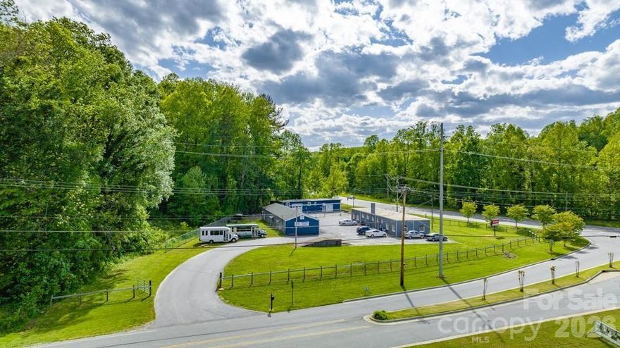 This versatile commercial real estate property is centrally located on a busy main thoroughfare just around the corner from downtown Lenoir, 30 min to Hickory, 20 min to Morganton and 40 min to Boone. Main property serves as a loading facility, retail office space & storage area, complete w/partial fencing. Currently, the property houses a diverse mix of tenants including a general contractor, an insurance agency & a local community church. Situated on a prime corner lot totaling almost 2 acres with two entrances this income-generating property benefits from high traffic volume and great exposure. With its level terrain, additional acreage, connection to city utilities, and natural gas onsite, this location presents an excellent opportunity for redevelopment and expansion. Also includes two lots across the road totaling an additional 1.96 +/- acres of vacant land. Take advantage of bustling commercial activity in area & capitalize on this unique property's potential for transformation.