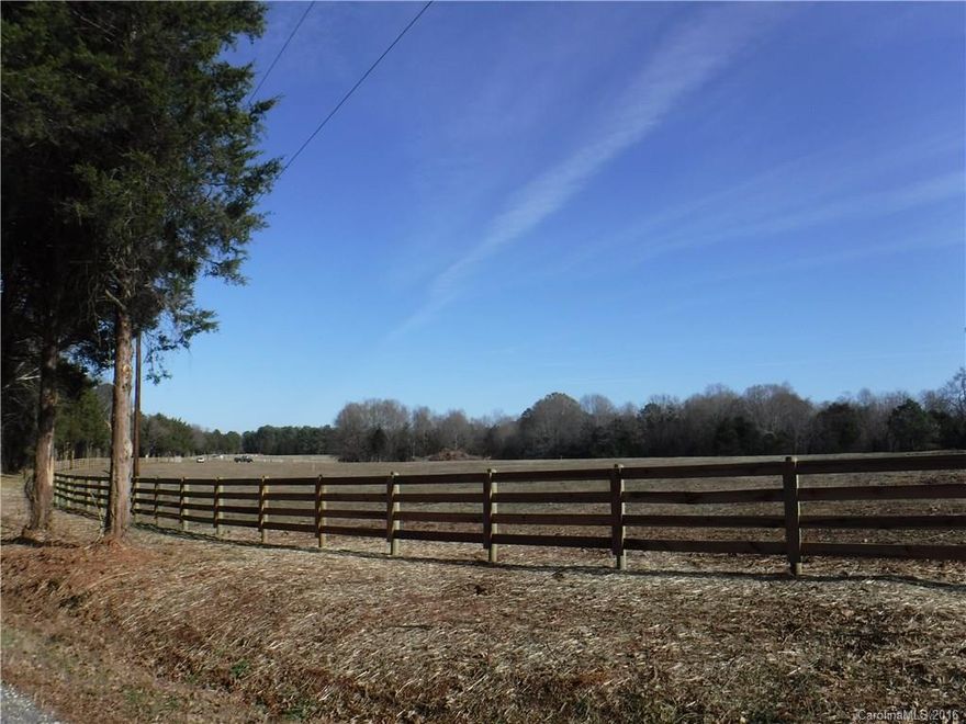 Beautiful setting ready for your dream home. See the individual entrances wired for light, 4 plank horse fencing surrounds 3 sides of the 5 acres. Any added fencing must match existing fences. Well and Septic required.