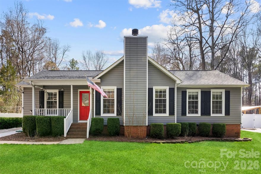 Charming ranch with an inviting fenced backyard, just under 5 minutes to downtown Belmont’s dining and shopping, with easy access to the airport and Uptown Charlotte. The spacious great room features vaulted beamed ceilings and is anchored by a cozy wood-burning fireplace. 3 bedrooms (per septic) plus a flexible fourth room ideal for an office or guest space. Detached garage/workshop with a spacious bonus space above. The home also features a custom garage gym and upgraded batting cage, creating a unique space for fitness, training, and recreation right at home. In 2023, electrical panels (20-year warranty) and smoke and carbon monoxide detectors (10-year warranty) were updated. Great opportunity in a sought-after Belmont location!